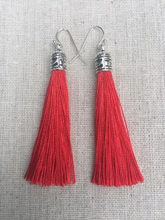 Chic red tassel earrings!  They would add a pop of color to any outfit for any occasion.  Dress them up or down.  They are timeless and versatile.  They are lightweight, fun and unique!The tassels measure 2 1/8” long by 1/4” wide.  They hang from simple silver ear wire hooks.  Overall drop length is about 2 1/4”.  Metal is allergy free plated silver.These are my latest creation!  I have them available in many colors!  Find them all under the category tassel earrings in my shop.Thanks for stoppin Red Tasseled Jewelry As A Gift, Red Tasseled Jewelry For Gift, Red Fringe Tassel Earrings As Gift, Red Fringe Tassel Earrings For Gift, Red Tassel Earrings With Fringe For Gift, Red Dangle Tassel Earrings As Gift, Red Dangle Tassel Earrings For Gift, Red Tassel Earrings For Gift, Red Bohemian Tassel Earrings As Gift