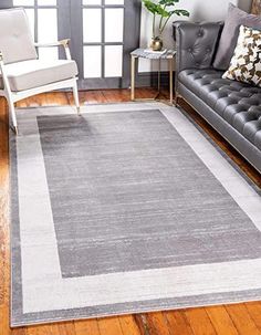 a living room filled with furniture and a gray rug