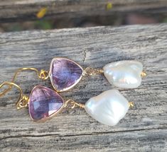 These elegant gold amethyst faceted crystals and  big baroque pearls earrings are  great for everyday use, parties, or for special occasions! It is made with big genuine baroque pearls, wire wrapped in gold filled wires, measures 9mm to 12 mm x 15mm to 17mm (big baroque, light). The color is natural white, pearls are lustrous. The pearl is attached to a amethyst purple glass connector bezel gold rhodium plated connector.  Material: Genuine Baroque Pearls, lustrous, wrinkled Size: 9mm to 12 mm x 15mm to 17mm Finding: gold plated ; amethyst  purple glass bezel connector. Length ( with ear hooks) is around 2 inches (  50 mm ). Note: Your jewelry will arrive beautifully and carefully packaged in a gift box with a pretty ribbon. Gold Amethyst Drop Earrings, Purple Pearl Earrings As Gift, Gold Amethyst Crystal Earrings, Gold Amethyst Crystal Earrings With Gemstone, Gold Amethyst Gemstone Crystal Earrings, Handmade Amethyst Crystal Earrings In Gold, Handmade Amethyst Wedding Earrings, Gold Amethyst Earrings For Parties, Handmade Amethyst Earrings For Wedding