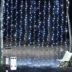 an outdoor area with lights and a remote control on the ground next to a chair