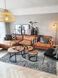 a living room with couches, tables and pictures on the wall in it's corner