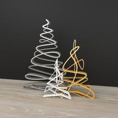 a metal christmas tree sitting on top of a wooden table