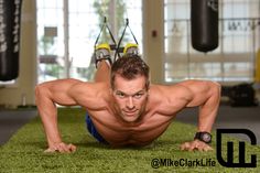 a man is doing push ups on the ground with his hands behind his head and feet