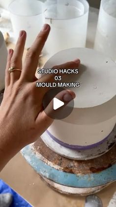 a person is making a cake with white frosting on it and the words studio hacks mould making are in front of them