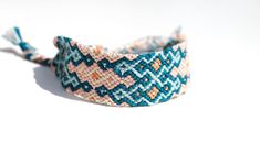 *BRACELET DETAILS  Beautiful semi thick, handwoven friendship bracelet with a stacked diamond pattern and the colors of Indian Blue, Light Blue, Millennial Pink, Terracotta, and Cream. The woven part of this bracelet is 2.5 centimeters wide and 14 centimeters long. There are braided ties on both ends. This bracelet is made out of 100% premium cotton string which not only means the colors are long lasting but also it lightweight to wear.  Packaging holder is made from recycled cardboard material. Pink Terracotta, Indian Blue, Bracelets Adjustable, String Bracelets, Millennial Pink, Diamond Stacks, Recycled Cardboard, Simple Bracelets, Cotton String