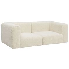 a white couch sitting on top of a white floor