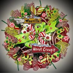 a wreath made out of candy canes and lollipops with the words whovillee on it