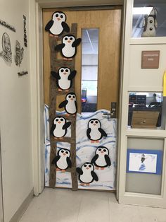 a door decorated with magnets and penguins