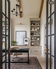 an open door leading to a room with white walls and black doors, along with a rug on the floor