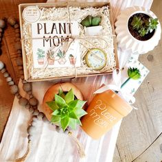 a plant mom box sitting on top of a table next to a cup and other items