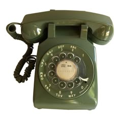 an old fashioned green phone is shown on a white background