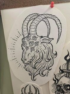 some stickers are hanging on the wall next to a paper with an image of a ram