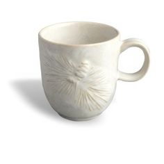 a white coffee cup with a flower design on the outside and inside, sitting in front of a white background