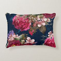 a blue pillow with pink flowers on it