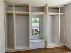 an empty room with unfinished walls and shelves