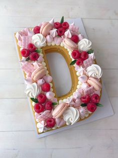 the letter d is decorated with flowers and icing