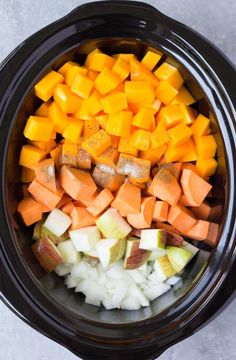 chopped vegetables in a slow cooker ready to be cooked