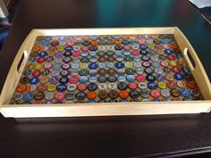 a tray with many different colored buttons on it