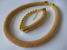 Small Czech seed beads in gold color. Very flexible and comfortable to wear. It is easy, elegant jewelry suitable for everyday use and special occasions. It is handmade especially for you. Necklace length 18.11 inch (46 cm). Bracelet length 9.06 inch (23 cm). Handmade Gold-plated Beaded Bracelets, Elegant Handmade Gold Beaded Bracelets, Elegant Gold Handmade Beaded Bracelets, Elegant Yellow Beaded Bracelets With Gold Beads, Elegant Yellow Beaded Bracelet With Gold Beads, Handmade Gold Jewelry Sets For Party, Gold Metal Beaded Necklace For Wedding, Gold Jewelry Sets With Round Beads For Parties, Wedding Gold Metal Beaded Necklaces