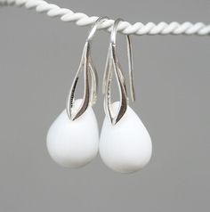 "Designed with czech glass briolette beads in opaque white color in a shape of drop. Ear wires: sterling silver 925 (European quality - we only use European silver!) You can choose: - regular hook ear wires - leverback Silver finish of earwires: - sterling silver 925 - 24K gold coated silver - black rhodium coated silver - rose gold coated silver * Total length of earrings is 28mm (1.1\") * Weight of each earring is about 2,2-2,4gr. Due to it is glass there can be bubbles inside teardrops. You w White Sterling Silver Teardrop Earrings For Gift, White Minimalist Hypoallergenic Teardrop Earrings, Nickel-free White Dangle Teardrop Earrings, White Dangle Teardrop Earrings, White Nickel-free Dangle Teardrop Earrings, White Sterling Silver Teardrop Pendant Earrings, White Sterling Silver Teardrop Earrings, Minimalist White Teardrop Earrings For Gift, White Modern Drop Earrings