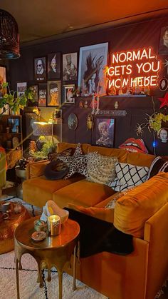 a living room filled with lots of furniture and pictures on the wall next to a coffee table