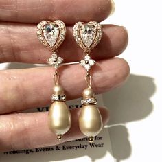 "One (1) pair of sparkly rose gold cz pearl drop bridal earrings made of clear cubic zirconia and unique champagne beige almond tone teardrop swarovski pearl dangles. Earrings are about 1 1/2\" (4cm) with sterling silver posts. View all rose gold jewelry at https://etsy.me/1mqy97w View all earrings at https://etsy.me/1f8VFT4" Champagne Pearl Earrings, Champagne Drop Earrings For Wedding, Champagne Crystal Wedding Jewelry, Champagne Rhinestones Wedding Jewelry, Elegant Champagne Dangle Earrings, Pearl Drop Bridal Earrings, Champagne Jewelry, Drop Bridal Earrings, Pearl Drop Earrings Bridal