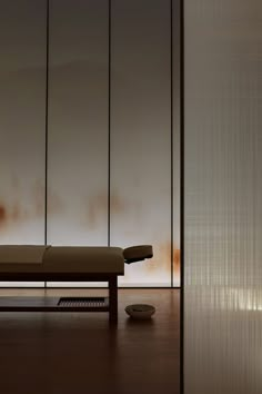 a room with a chair and a table in front of a wall that has brown stains on it