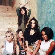 the girls are posing together on the stairs