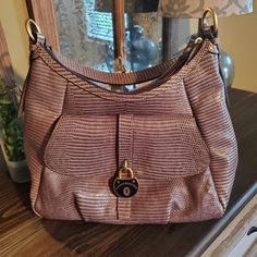 Gently Used. Excellent Condition. No Signs Of Wear. Inside Is Clean. Santorini Lizzard Embossed Leather Hobo. Gray With Brushed Gold Hardwear Approximate Measurements 13x 12 No Lowball Offers Please. Printed Purse, Leather Hobo, Dooney Bourke, Santorini, Embossed Leather, Diaper Bag, Gray Color, Bag Lady, Purse