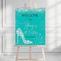 a welcome sign with a high heel shoe on the front and blue sparkles in the background