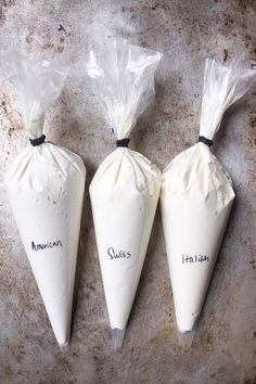 three cones are wrapped in plastic and have writing on them