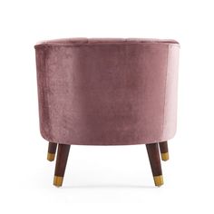 a pink velvet chair with wooden legs