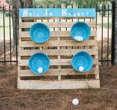 a wooden pallet with bowls and balls on it