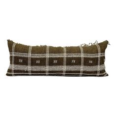 a brown and white checkered pillow with fringes on the edges, sitting on a white background