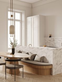 a kitchen with marble counter tops and white walls