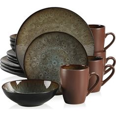 a set of brown and black dishes with matching coffee mugs, plates and bowls