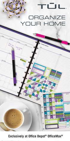 a desk with a cup of coffee, pen and planner on it