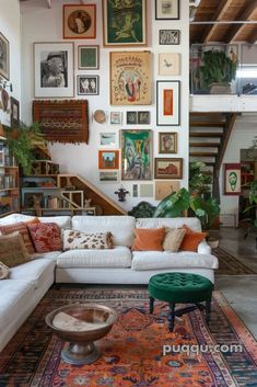 a living room filled with lots of furniture and pictures on the wall above it's stairs