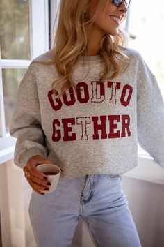 Grey long sleeve crewneck sweater that features a 'Better Together' logo in burgundy. This sweater is the perfect casual-chic wardrobe addition. Our model also wears the Grey Preston Skort and the Light Blue Maddie Jeans Sizes: S-M / M-L S-M: Length 24.02 in - Width 22.44 in M-L: Length 24.41 in - Width 23.62 in 50% cotton - 50% polyester Washing: handwash only Long Sleeve Fall Sweater For College, Long Sleeve Sweater For College In Fall, Cozy Fall Sweater For College, Cozy Fall College Sweater, Cozy Crew Neck Tops For Fall, Fall Loungewear Crew Neck Sweater, Crew Neck Sweater With Letter Print For Fall, Fall College Sweater With Ribbed Cuffs, Fall Crew Neck Sweater With Letter Print