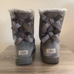 Soft Fuzzy Grey, Two Grey Bows On The Back Of Each Shoe. Ugg Brand. Worn, But In Fantastic Condition. Shoes Uggs, Cute Uggs, Uggs With Bows, Fuzzy Boots, Ugg Bailey, Bow Boots, Womens Uggs, Ugg Shoes, Rain Boots