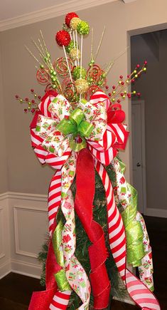 a christmas tree decorated with candy canes and bows