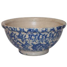 a blue and white bowl sitting on top of a table