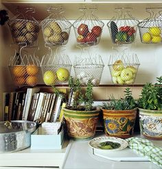 various fruits and vegetables are displayed in baskets on the wall behind a stove top oven