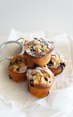 blueberry muffins with powdered sugar on top