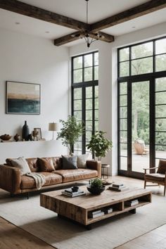 a living room filled with furniture and lots of windows in front of large open doors