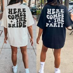 two women wearing t - shirts that say here comes the party and here comes the bride