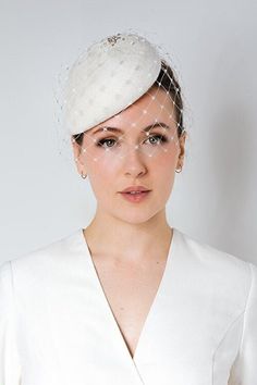 Olive is a beautiful wedding birdcage veil hat with a modern style oversize veil and fine diamanté detailing. This hat is made to order from high-quality velour felt, hand-made by me in my studio in Scotland.  This elegant bride's hat would work well with a structured dress or wedding suit but is equally suitable for a vintage-style wedding. The hat can be finished with different detailing (shown in the images and video), however, this is a bespoke request, so please get in touch in the first in Birdcage Veil Wedding, Veil Hat, Bridal Hats, Olive Wedding, Wedding Birdcage, Veiled Hats, Bride Hat, Bridal Hat, Birdcage Veil