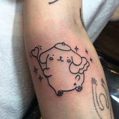 a person with a tattoo on their arm has a drawing of a dog and stars