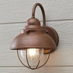 an old fashioned wall light on the side of a house