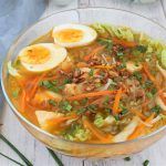 a bowl filled with soup and boiled eggs